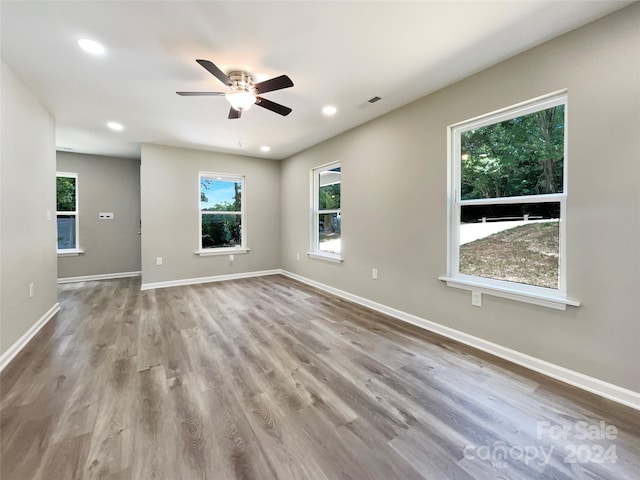 spare room featuring ceiling fan and light hardwood / wood-style flooring