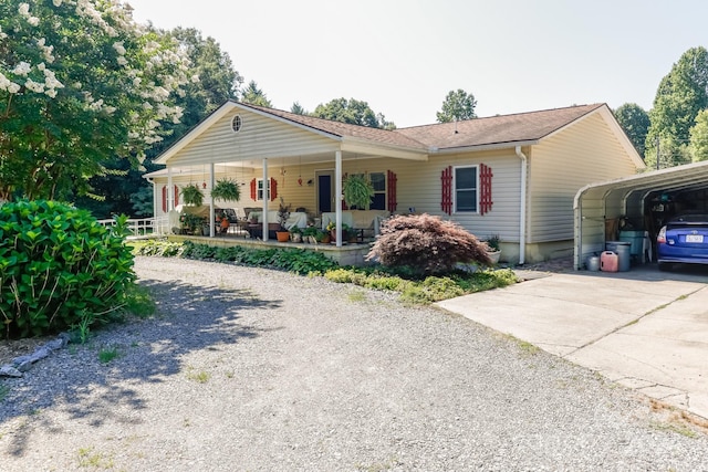 ranch-style home with covered porch and a carport