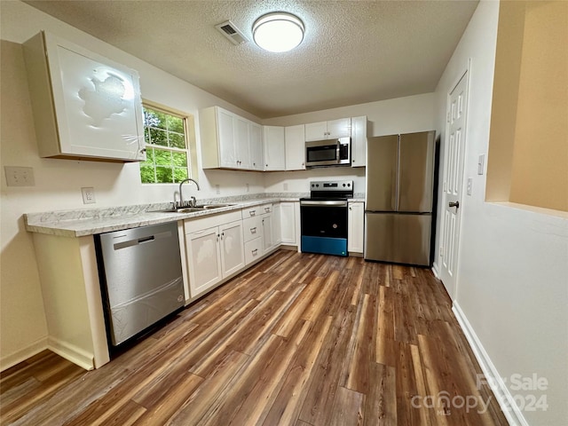 kitchen featuring sink, white cabinetry, and appliances with stainless steel finishes