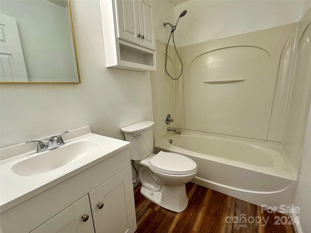 full bathroom featuring toilet, vanity, hardwood / wood-style floors, and tub / shower combination