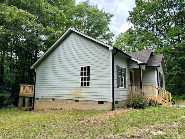 view of side of home with a yard