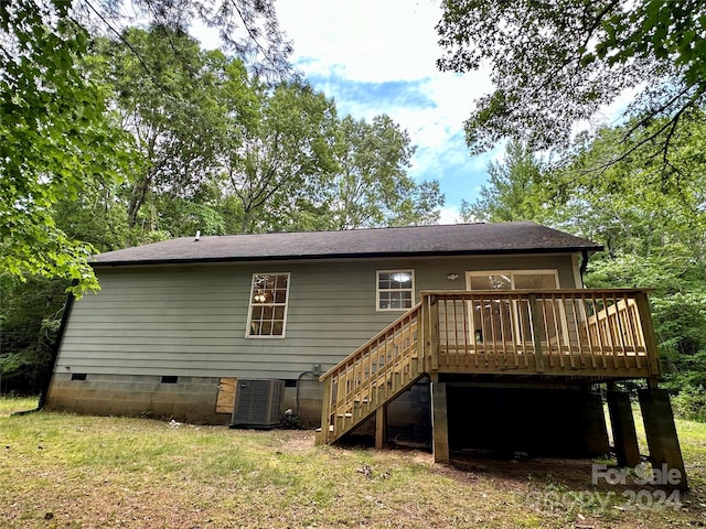 back of house with a yard, a deck, and central AC unit