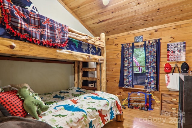 bedroom featuring hardwood / wood-style flooring, lofted ceiling, wood walls, and wood ceiling