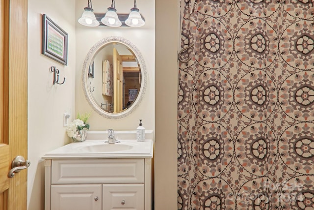 bathroom with walk in shower and vanity