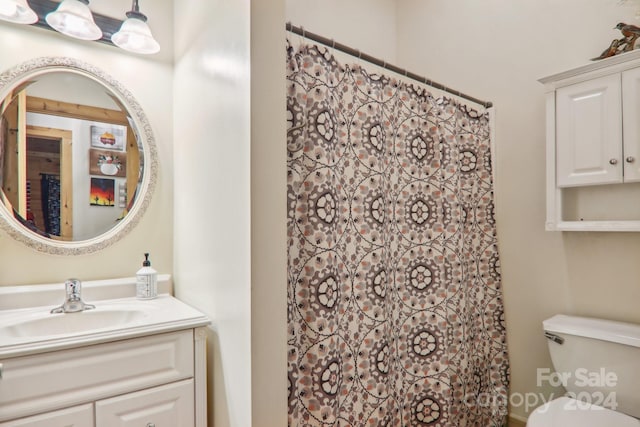 bathroom featuring toilet and vanity