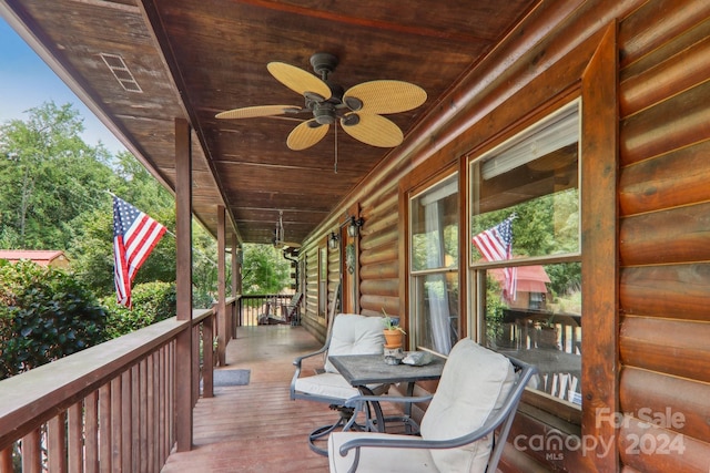 wooden deck featuring ceiling fan and covered porch