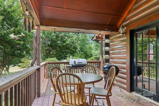 wooden terrace featuring a grill