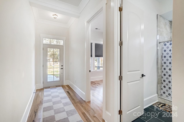 entrance foyer with crown molding and wood-type flooring