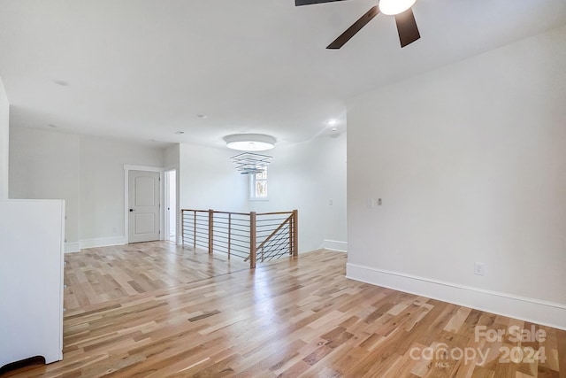 empty room featuring ceiling fan and light hardwood / wood-style flooring