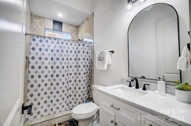 bathroom with tile patterned floors, curtained shower, vanity, and toilet