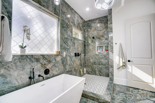 bathroom with shower with separate bathtub and tile walls