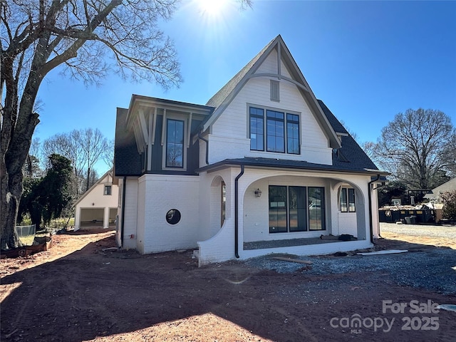 view of front of property featuring driveway and brick siding