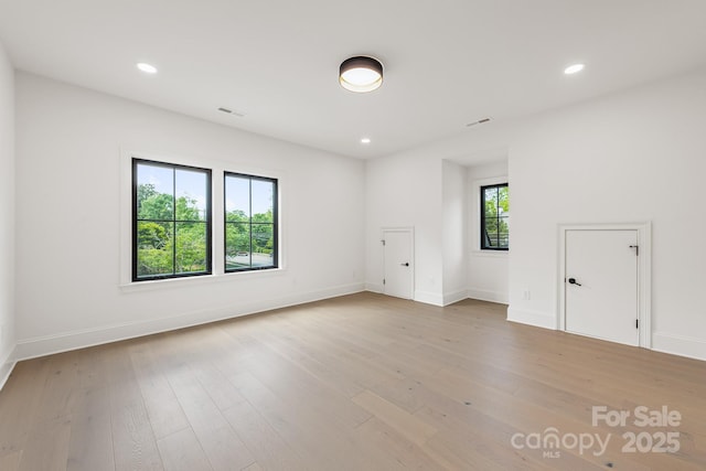 unfurnished room with light wood-type flooring, recessed lighting, baseboards, and visible vents