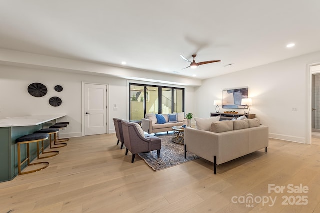 living area featuring recessed lighting, light wood-style flooring, and ceiling fan