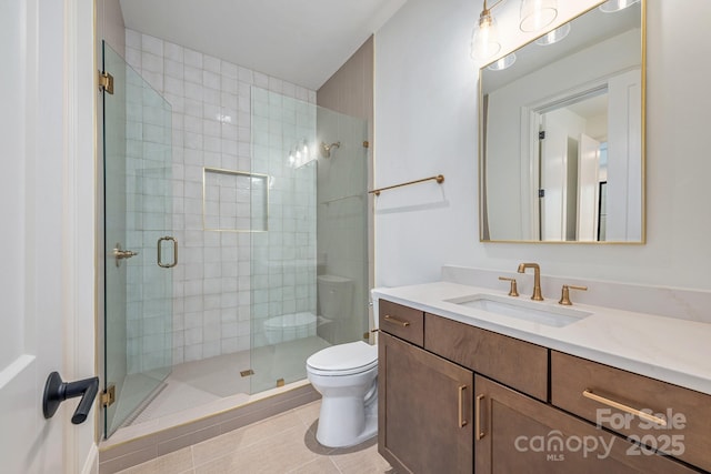 bathroom with vanity, tile patterned floors, a shower stall, and toilet