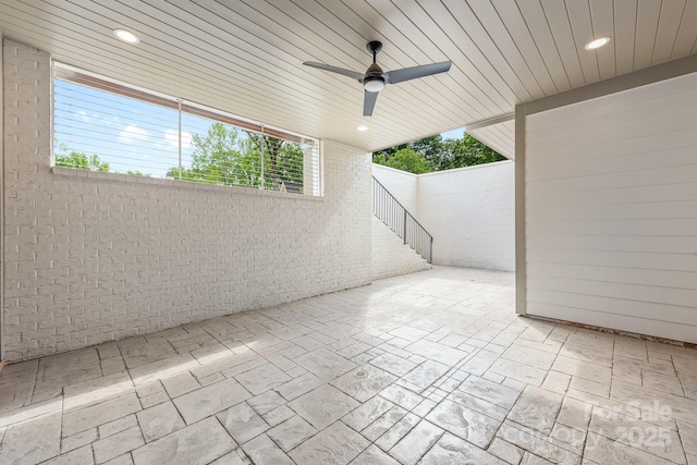 view of patio / terrace with stairway and a ceiling fan