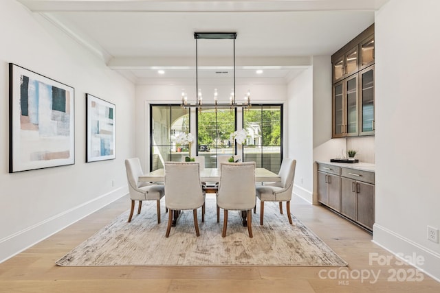 dining area with recessed lighting, light wood finished floors, baseboards, and a chandelier