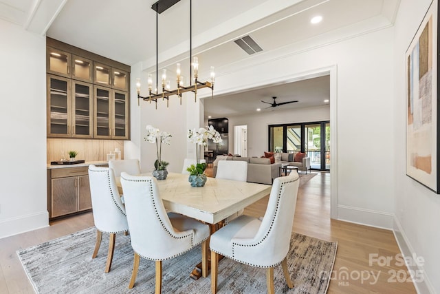 dining space with baseboards, visible vents, and light wood-style flooring