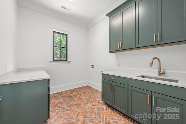 washroom with visible vents, hookup for a washing machine, brick floor, a sink, and cabinet space