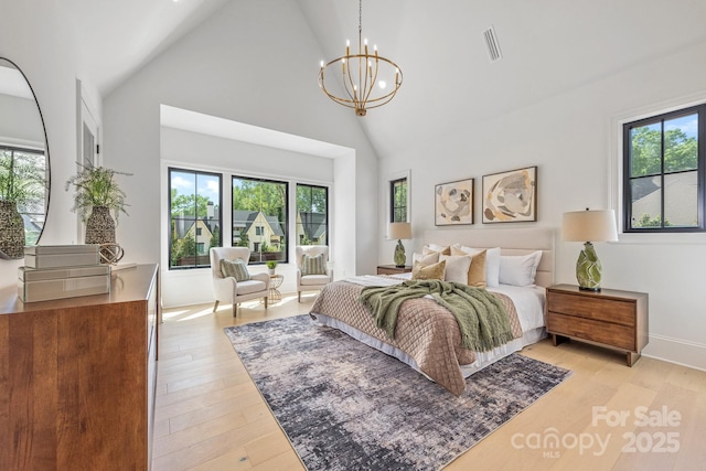 bedroom with visible vents, high vaulted ceiling, multiple windows, and an inviting chandelier
