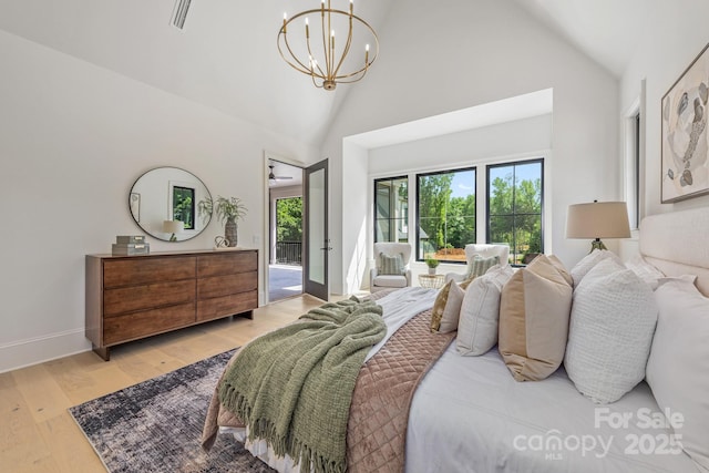 bedroom featuring high vaulted ceiling, baseboards, a notable chandelier, light wood-style floors, and access to outside