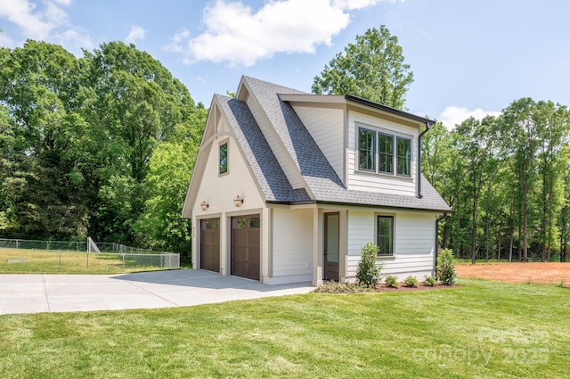 view of front of home with fence, a shingled roof, an attached garage, a front yard, and driveway