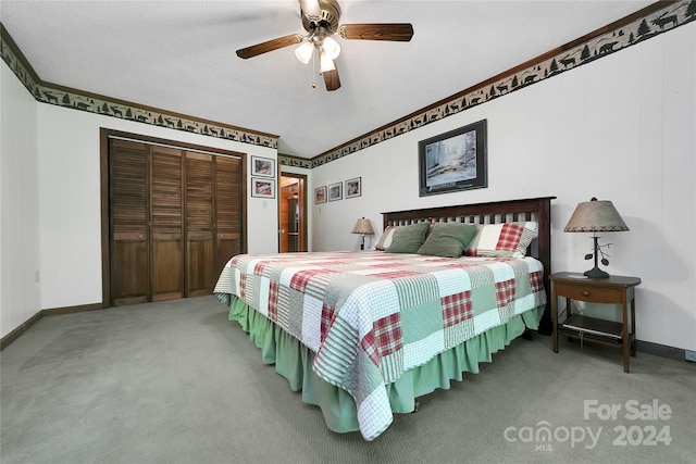 carpeted bedroom featuring a closet and ceiling fan