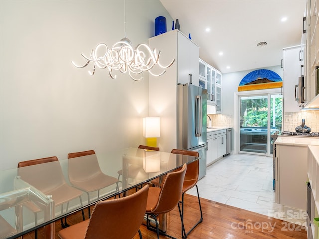 dining room featuring a notable chandelier and sink