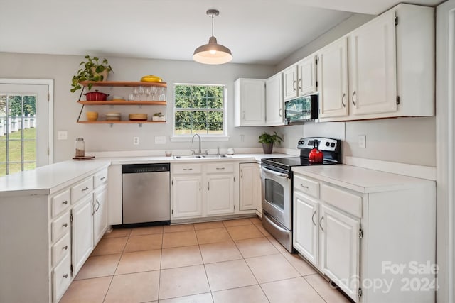 kitchen featuring sink, decorative light fixtures, plenty of natural light, white cabinetry, and appliances with stainless steel finishes