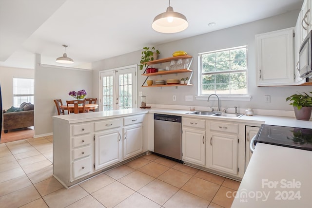 kitchen featuring pendant lighting, white cabinets, kitchen peninsula, and stainless steel dishwasher