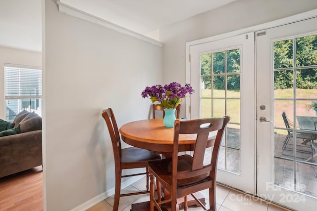 dining space with light tile patterned floors, french doors, and plenty of natural light