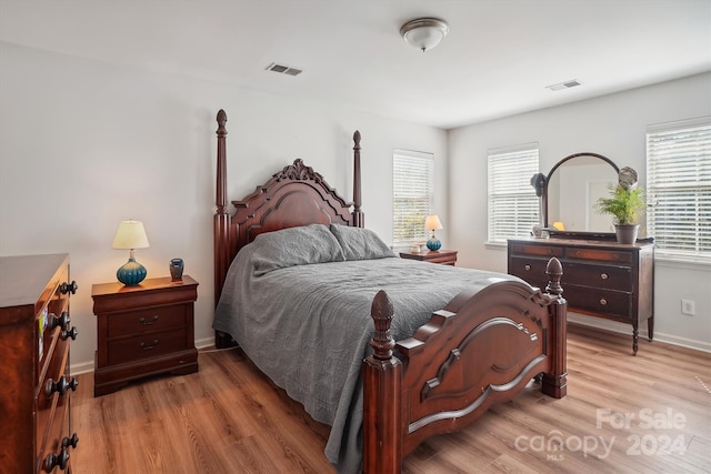 bedroom featuring light hardwood / wood-style flooring and multiple windows