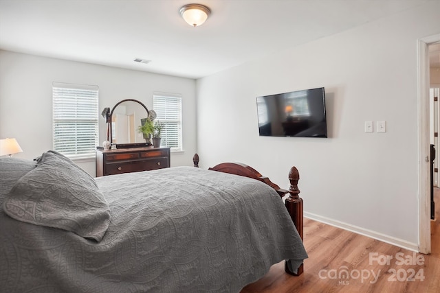 bedroom featuring light hardwood / wood-style floors and multiple windows