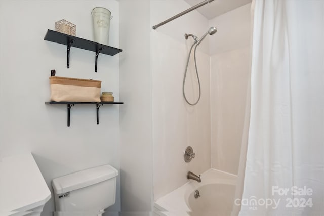 bathroom featuring toilet and shower / bathtub combination with curtain