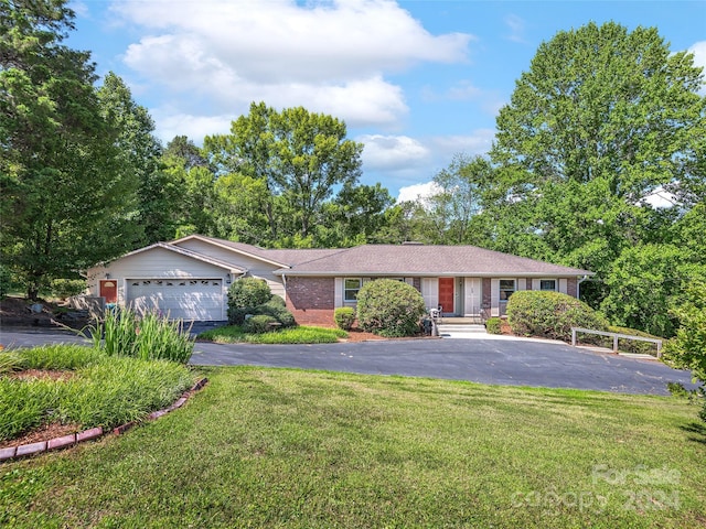 ranch-style home featuring a garage and a front lawn