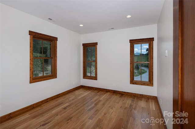 spare room with light hardwood / wood-style floors