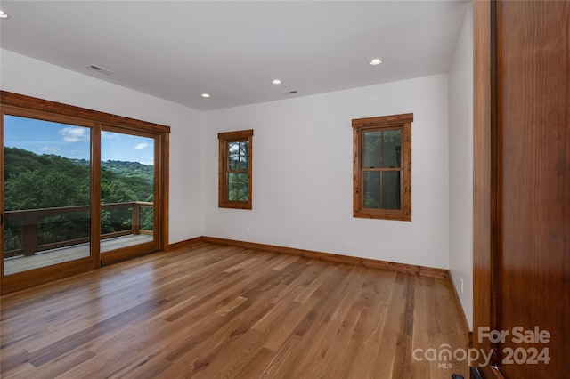 empty room featuring hardwood / wood-style flooring