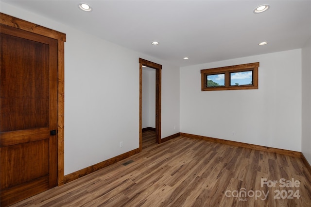 empty room with hardwood / wood-style flooring