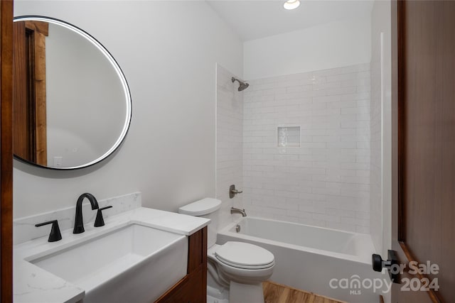 full bathroom with toilet, vanity, tiled shower / bath combo, and hardwood / wood-style flooring