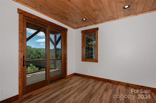 entryway with plenty of natural light, hardwood / wood-style floors, crown molding, and wood ceiling