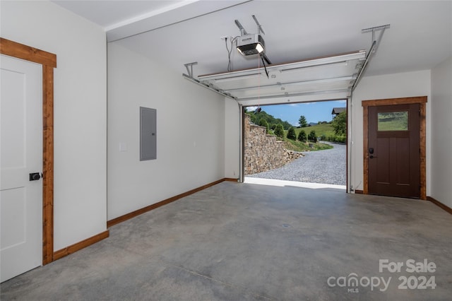 garage with a garage door opener and electric panel