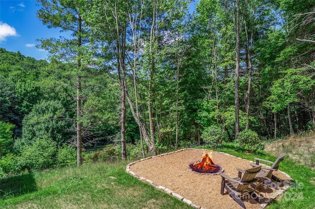 view of yard with an outdoor fire pit