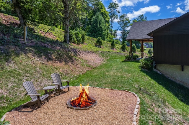 view of yard with a fire pit