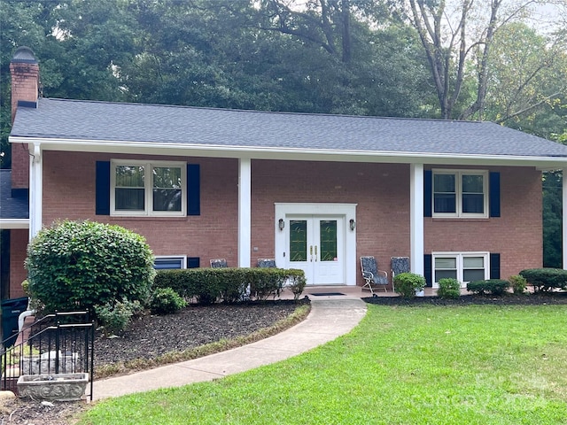 split foyer home featuring french doors and a front lawn