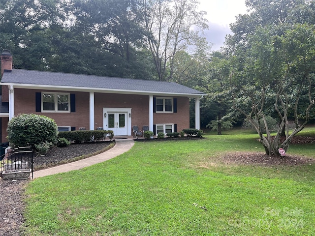 split foyer home featuring a front yard and french doors