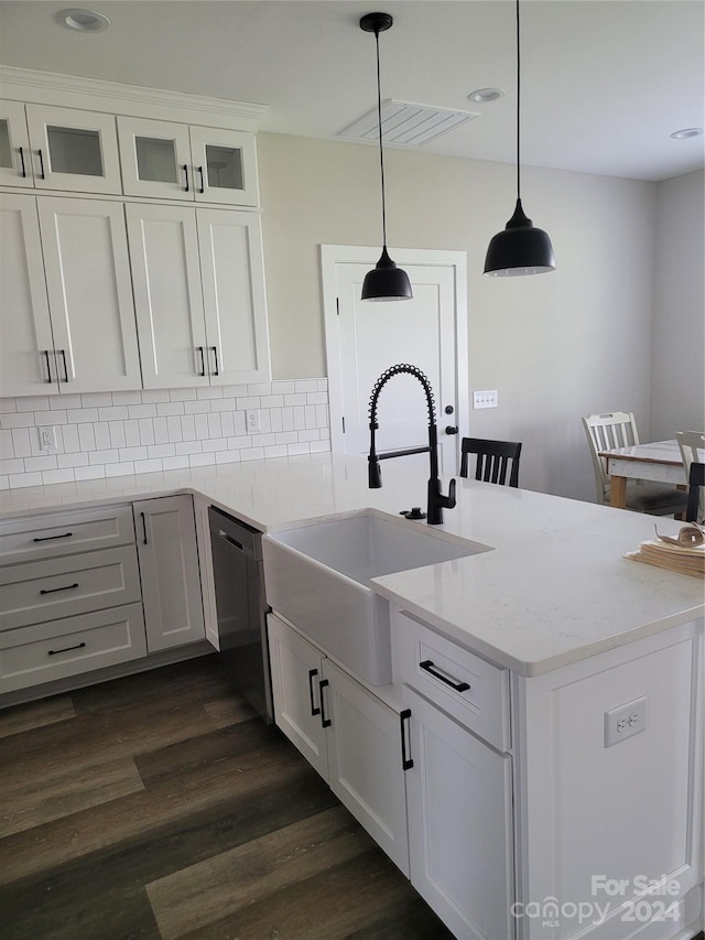 kitchen with sink, hanging light fixtures, backsplash, stainless steel dishwasher, and dark wood-type flooring