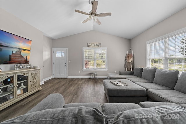 living room featuring dark hardwood / wood-style floors, ceiling fan, lofted ceiling, and a healthy amount of sunlight