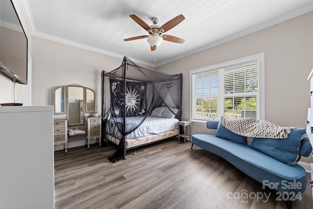 bedroom featuring ornamental molding, ceiling fan, and hardwood / wood-style floors