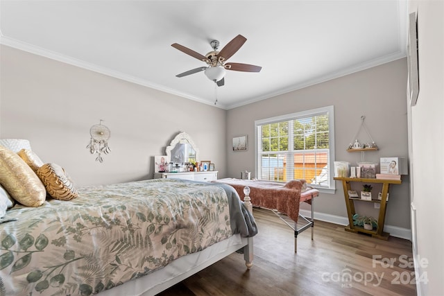 bedroom with ceiling fan, wood-type flooring, and ornamental molding