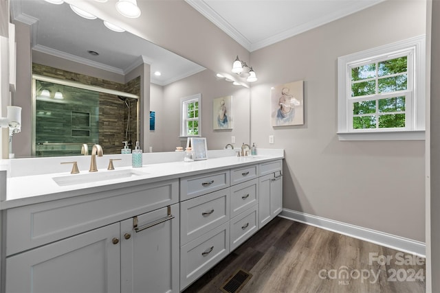 bathroom with hardwood / wood-style flooring, double sink vanity, crown molding, and an enclosed shower